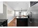 Spacious kitchen with black island, stainless steel refrigerator, and hardwood floors at 4850 Guilford Ave, Indianapolis, IN 46205