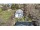 Birds eye view of a detached garage on a grassy lot surrounded by bare trees and neighboring houses at 5110 Chelsea Rd, Indianapolis, IN 46241
