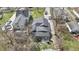 Aerial view of the property featuring a gray roof, small yard, and mature trees at 5110 Chelsea Rd, Indianapolis, IN 46241