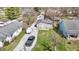 Aerial view of the property and adjacent homes surrounded by mature trees at 5110 Chelsea Rd, Indianapolis, IN 46241
