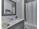 Neat bathroom featuring a gray vanity with a marble countertop and a tub with a shower, offering a clean functional space at 5110 Chelsea Rd, Indianapolis, IN 46241