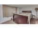 Cozy bedroom features soft lighting, a simple dark bed frame, wood-look floors, and an inviting ambiance at 5110 Chelsea Rd, Indianapolis, IN 46241