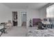 Functional bedroom featuring soft gray carpet, access to closet and hall, a desk, and simple furnishings for flexible living at 5110 Chelsea Rd, Indianapolis, IN 46241