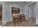 Bright dining room with wood flooring, seating for four, and a view to kitchen at 5110 Chelsea Rd, Indianapolis, IN 46241