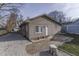 Cozy single-story house featuring neutral siding and a small tiled patio area at 5110 Chelsea Rd, Indianapolis, IN 46241