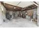 Interior view of the large detached garage with exposed beam ceiling and cinder block walls at 5110 Chelsea Rd, Indianapolis, IN 46241