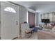 Bright living area with a white door, neutral walls, and a comfortable sofa at 5110 Chelsea Rd, Indianapolis, IN 46241