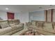Comfortable living room showcasing reclining sofas, neutral carpet, and round glass table, ideal for relaxation and entertaining at 5110 Chelsea Rd, Indianapolis, IN 46241