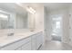 Bathroom featuring dual sinks, white cabinets, and a separate shower with decorative tile at 5314 Noble Crossing W Pkwy, Noblesville, IN 46062