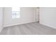 Bright bedroom features plush gray carpeting, a window, and a doorway at 5314 Noble Crossing W Pkwy, Noblesville, IN 46062