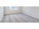 Bright bedroom features plush gray carpeting, a window, and a doorway at 5314 Noble Crossing W Pkwy, Noblesville, IN 46062