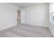 Bright bedroom features plush gray carpeting, a window, and a doorway at 5314 Noble Crossing W Pkwy, Noblesville, IN 46062