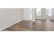 A bright entryway features laminate flooring, white door, and three windows at 5314 Noble Crossing W Pkwy, Noblesville, IN 46062
