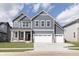 Charming two-story home with gray siding, white trim, well-manicured lawn, and a two car garage at 5314 Noble Crossing W Pkwy, Noblesville, IN 46062