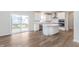 Open-concept kitchen features white cabinets, stainless steel appliances, and an island at 5314 Noble Crossing W Pkwy, Noblesville, IN 46062
