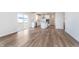 Bright kitchen with stainless steel appliances, white cabinets, and an island, opening to a wooden deck at 5314 Noble Crossing W Pkwy, Noblesville, IN 46062