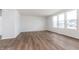 A large living room features three windows, an entry doorway, and laminate flooring at 5314 Noble Crossing W Pkwy, Noblesville, IN 46062