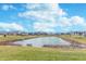 Scenic pond view with lush green surroundings and beautiful homes in a well-maintained neighborhood under a sunny sky at 5314 Noble Crossing W Pkwy, Noblesville, IN 46062