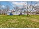 Spacious backyard with mature trees, storage shed, and plenty of room for outdoor activities at 5902 Sunset Dr, Indianapolis, IN 46239