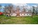 The backyard features mature trees, a shed, and an outdoor grill at 5902 Sunset Dr, Indianapolis, IN 46239