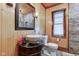 Bathroom features a modern vessel sink, wood plank walls, and framed mirror at 5902 Sunset Dr, Indianapolis, IN 46239