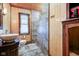 Bathroom features a modern vessel sink, standing shower with tile surround, and wood plank walls at 5902 Sunset Dr, Indianapolis, IN 46239