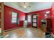 Bright bedroom with hardwood floors, large windows, unique door and window trim, and neutral gray paint at 5902 Sunset Dr, Indianapolis, IN 46239