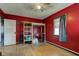 Bedroom featuring hardwood floors and unique door and window trim, with ample space and neutral gray paint at 5902 Sunset Dr, Indianapolis, IN 46239