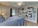 Bedroom featuring hardwood floors, ample shelf space for storage, with a tv included on the shelf at 5902 Sunset Dr, Indianapolis, IN 46239
