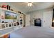 Cozy bedroom with hardwood floors and ample space with a tv included on a custom shelf for storage at 5902 Sunset Dr, Indianapolis, IN 46239