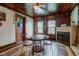 Dining room featuring a round table, fireplace, and rustic accents at 5902 Sunset Dr, Indianapolis, IN 46239