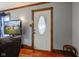 Interior view of an entryway with decorative woodwork and a front door with an oval glass insert at 5902 Sunset Dr, Indianapolis, IN 46239