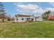 A charming single-story home showing a large yard, detached garage, and a porch with a swing at 5902 Sunset Dr, Indianapolis, IN 46239