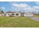 Charming single-story home featuring a front porch swing and a detached two-car garage at 5902 Sunset Dr, Indianapolis, IN 46239