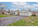 Quaint single-story home with a detached two-car garage and a cracked driveway at 5902 Sunset Dr, Indianapolis, IN 46239