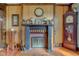 Close up of a fireplace with mantel, decorative accents, and wood paneled wall at 5902 Sunset Dr, Indianapolis, IN 46239