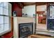 Fireplace with a decorative mantel and a view into an adjacent room with dining table at 5902 Sunset Dr, Indianapolis, IN 46239