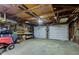 Spacious two car garage with storage and riding lawn mower at 5902 Sunset Dr, Indianapolis, IN 46239