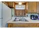 Kitchen sink area featuring wood cabinets, stainless steel sink, and a window view at 5902 Sunset Dr, Indianapolis, IN 46239