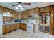 Kitchen featuring wood cabinets, white appliances, and decorative pantry doors at 5902 Sunset Dr, Indianapolis, IN 46239