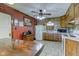 Traditional kitchen with wood cabinets, white appliances, and a rustic red wall at 5902 Sunset Dr, Indianapolis, IN 46239