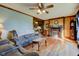 Inviting living room featuring rustic wood paneling, a fireplace, and hardwood floors at 5902 Sunset Dr, Indianapolis, IN 46239