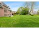 Expansive backyard with lush green lawn and mature trees, perfect for outdoor activities and relaxation at 6010 Fawnwood Dr, Greenwood, IN 46143