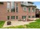 Brick home exterior with a concrete patio and walk-out basement entrance at 6010 Fawnwood Dr, Greenwood, IN 46143