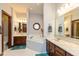 Bright bathroom featuring dual vanities, a soaking tub, and tiled floors at 6010 Fawnwood Dr, Greenwood, IN 46143