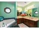 Inviting bathroom featuring dual vanities, a soaking tub, and stylish tile work at 6010 Fawnwood Dr, Greenwood, IN 46143