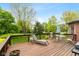 Wooden deck with outdoor furniture and views of the expansive, tree-filled backyard at 6010 Fawnwood Dr, Greenwood, IN 46143