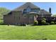 Backyard view of this beautiful home features a brick exterior, walkout basement and landscaped grounds at 6010 Fawnwood Dr, Greenwood, IN 46143