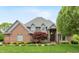 Charming brick home featuring lush landscaping, a well-manicured lawn, and an elegant front entrance at 6010 Fawnwood Dr, Greenwood, IN 46143