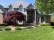 Stunning home with well-maintained lawn and landscaping, featuring an arched front door and bay window at 6010 Fawnwood Dr, Greenwood, IN 46143